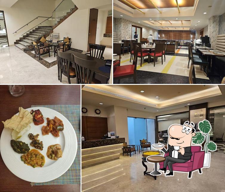 Take a seat at one of the tables at Rainbow Exclusively Veg Restaurant