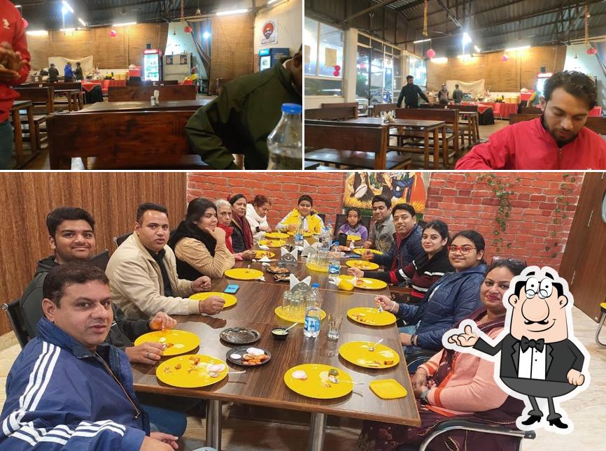 Take a seat at one of the tables at Kesar dhaba & family restaurant