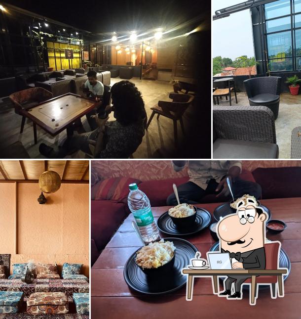 Take a seat at one of the tables at Qainaat The Rooftop Cafe
