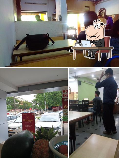 Take a seat at one of the tables at Hotel Sheela Sagar Veg