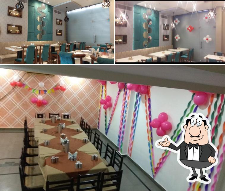 Take a seat at one of the tables at Arihant Restaurant & Banquet