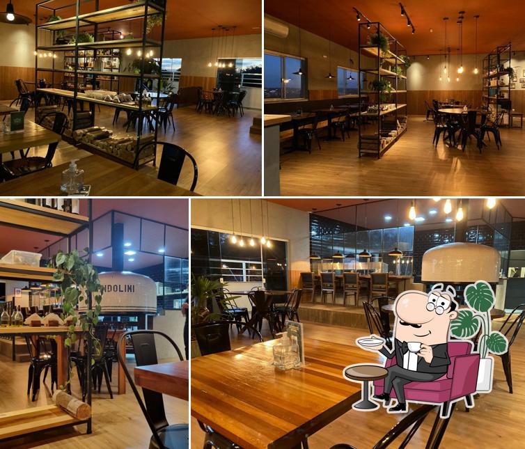 Sente em uma das mesas no Andolini Pizzeria