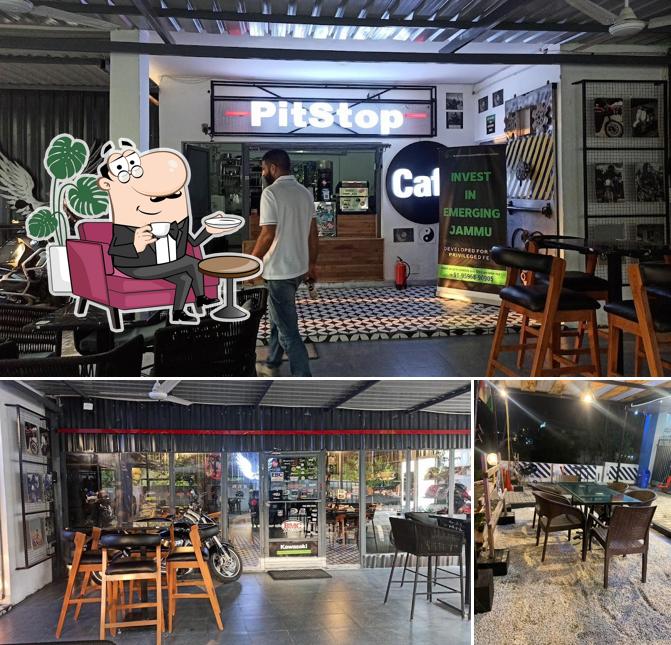 Take a seat at one of the tables at PitStop The Riders Cafe Jammu