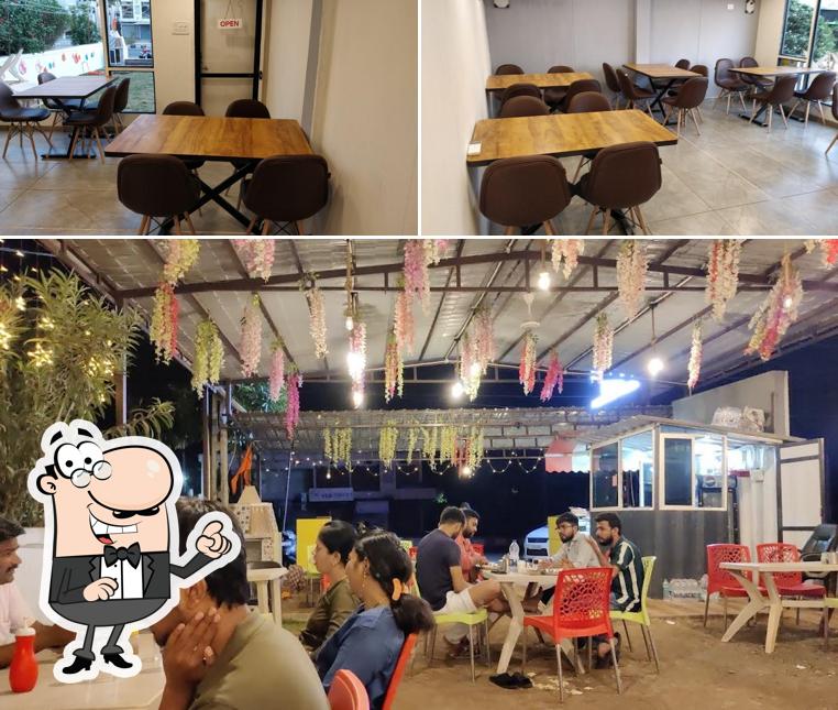 Take a seat at one of the tables at Hungry Kitchen Rajpipla