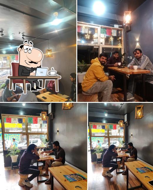 Take a seat at one of the tables at The Organic Bowl Best Cafe In Manali Coffee Place