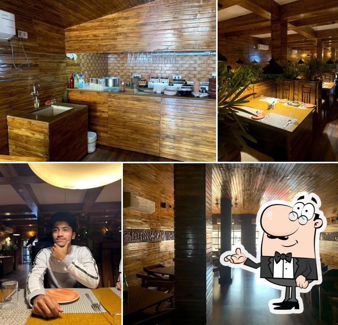 Take a seat at one of the tables at Hotel Woods (Cafe & Restaurant)