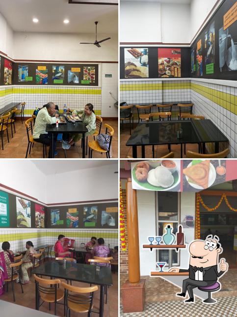 Take a seat at one of the tables at Halli Mane (Vegetarian Restaurant)