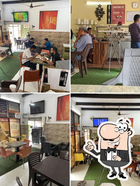 Take a seat at one of the tables at Bhatura Co. / Bhatura Company Ardee City Sector 52 ( Single outlet, no other branch or franchise )