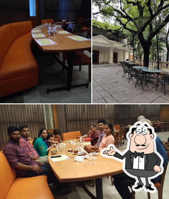 Take a seat at one of the tables at Kshetra Vegetarian Restaurant
