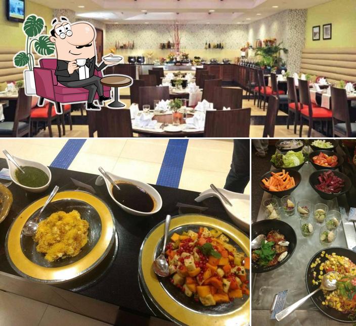 Take a seat at one of the tables at Rainbow Exclusively Veg Restaurant