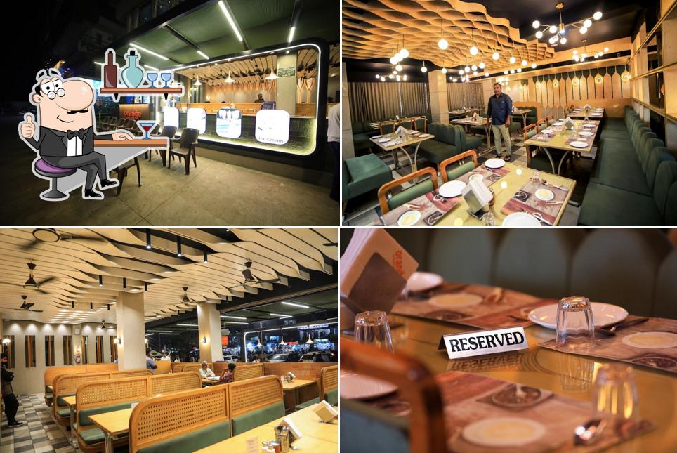 Take a seat at one of the tables at Orange Resturant & Banquet