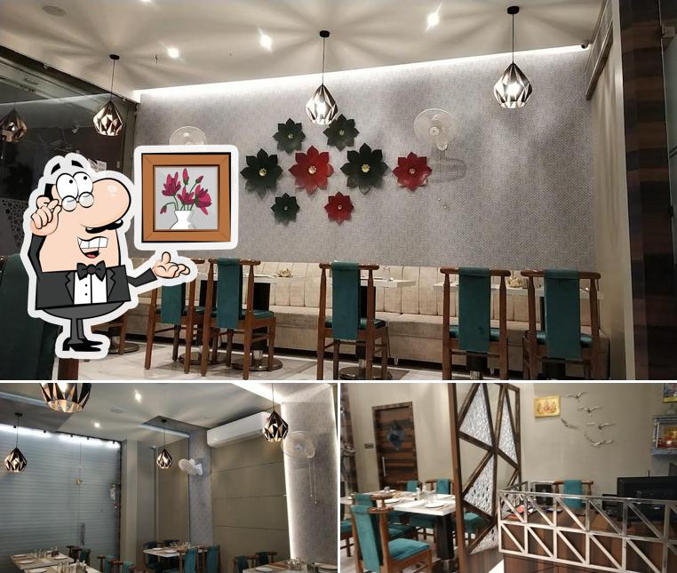 Take a seat at one of the tables at Arihant Restaurant & Banquet