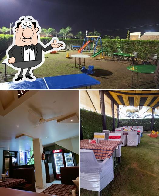 Take a seat at one of the tables at HOTEL K9 FAMILY GARDEN RESTO BAR
