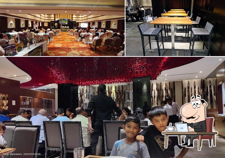 Take a seat at one of the tables at COCOON HOTEL SANGLI