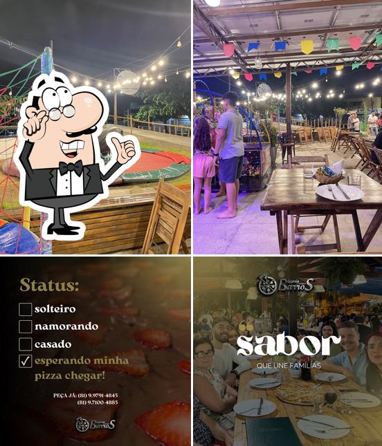 Sente em uma das mesas no Pizzaria Barros