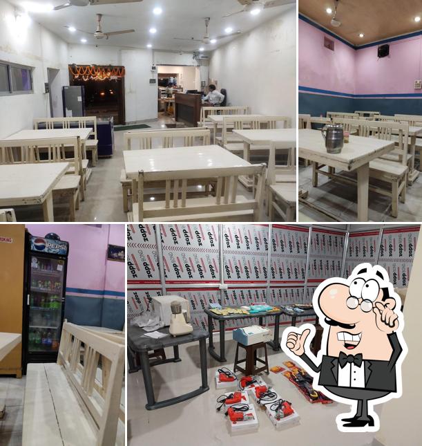 Take a seat at one of the tables at AOUNKAR HOTEL (SINCE-1982)