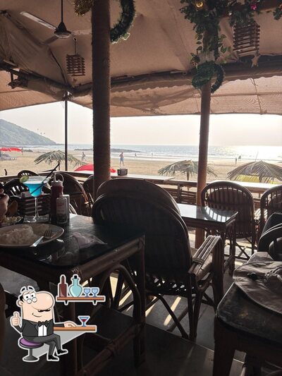Take a seat at one of the tables at Fishtail Bar & Restaurant - Best Bar In Vagator Beach Goa